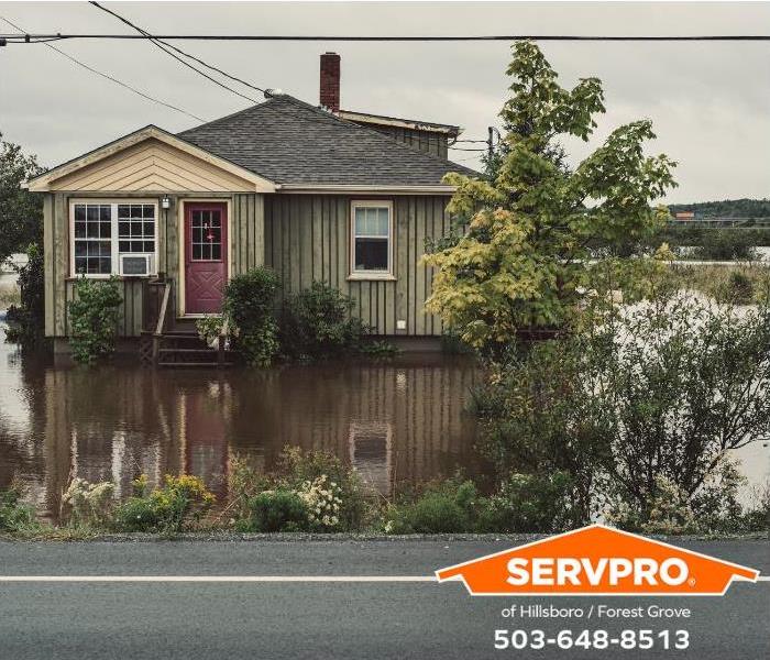 A home has flood waters surrounding it from a recent storm.
